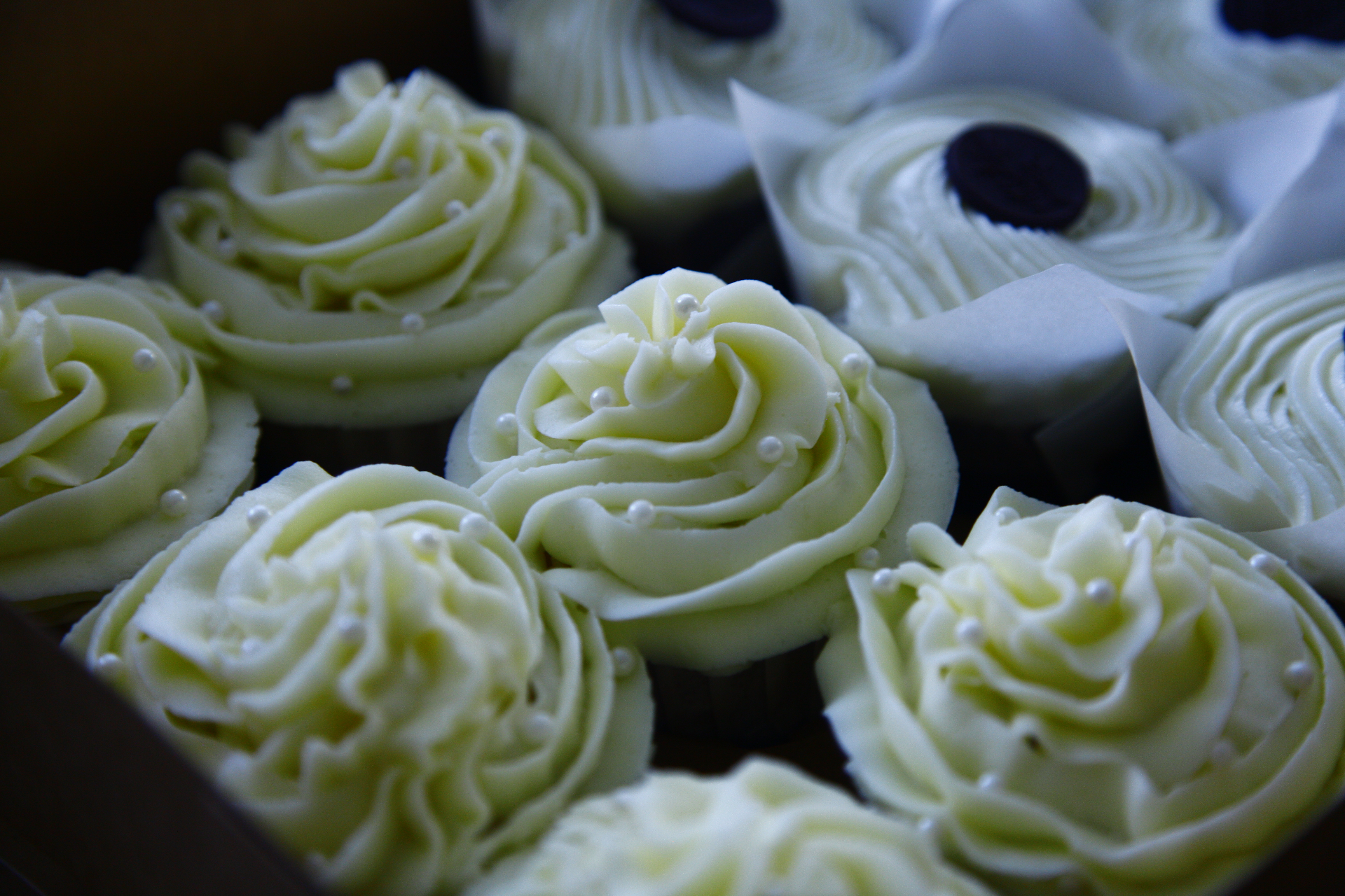 Cupcakes arranged on a pink marble surface